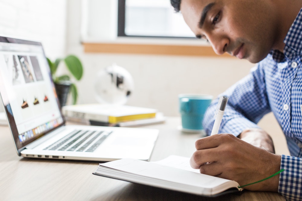 Young Man Writing in a Book