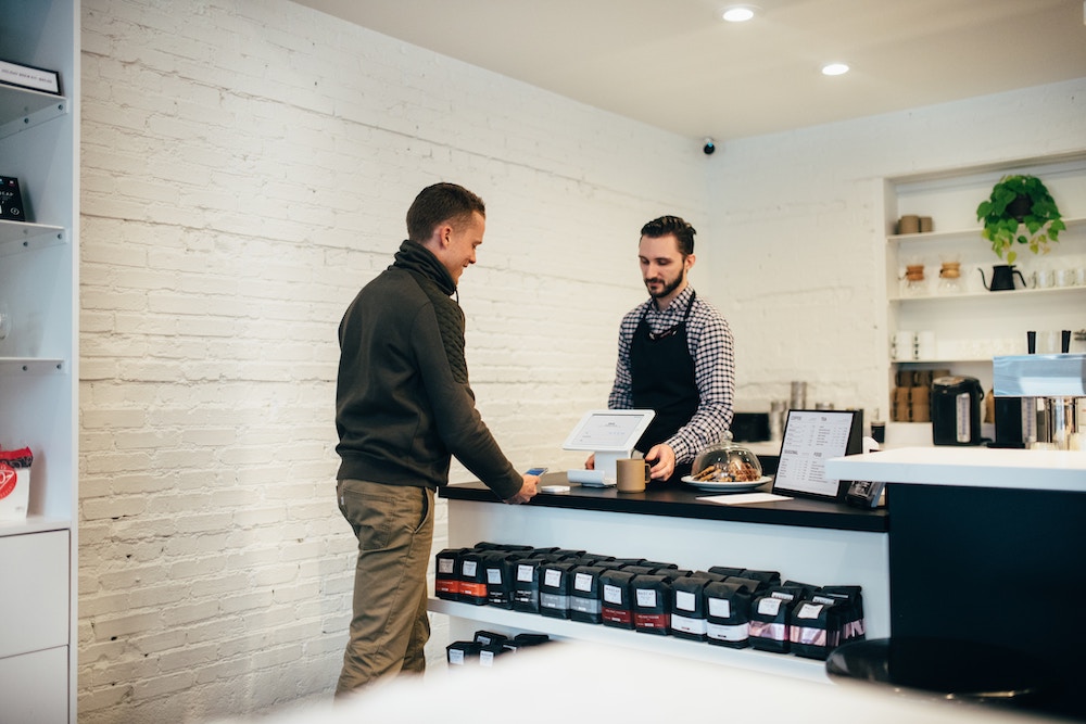 Man Purchasing an Item at a Shop