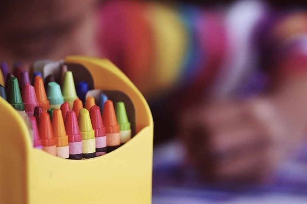 Child-Care-1 blurry photo of child coloring with crayons
